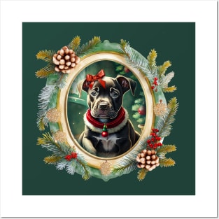 A cute black puppy dog wearing a festive bow and dog collar, in a winter Christmas picture frame with pinecones and winter berries Posters and Art